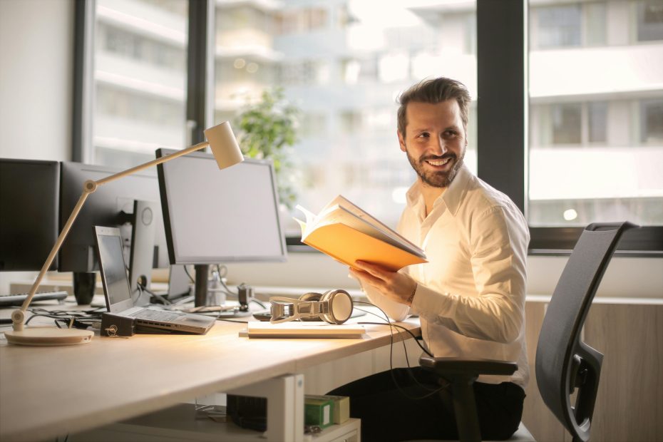 PHOTO OF MAN HOLDING A BOOKSAÚDE MENTAL E AMBIENTE DE TRABALHO